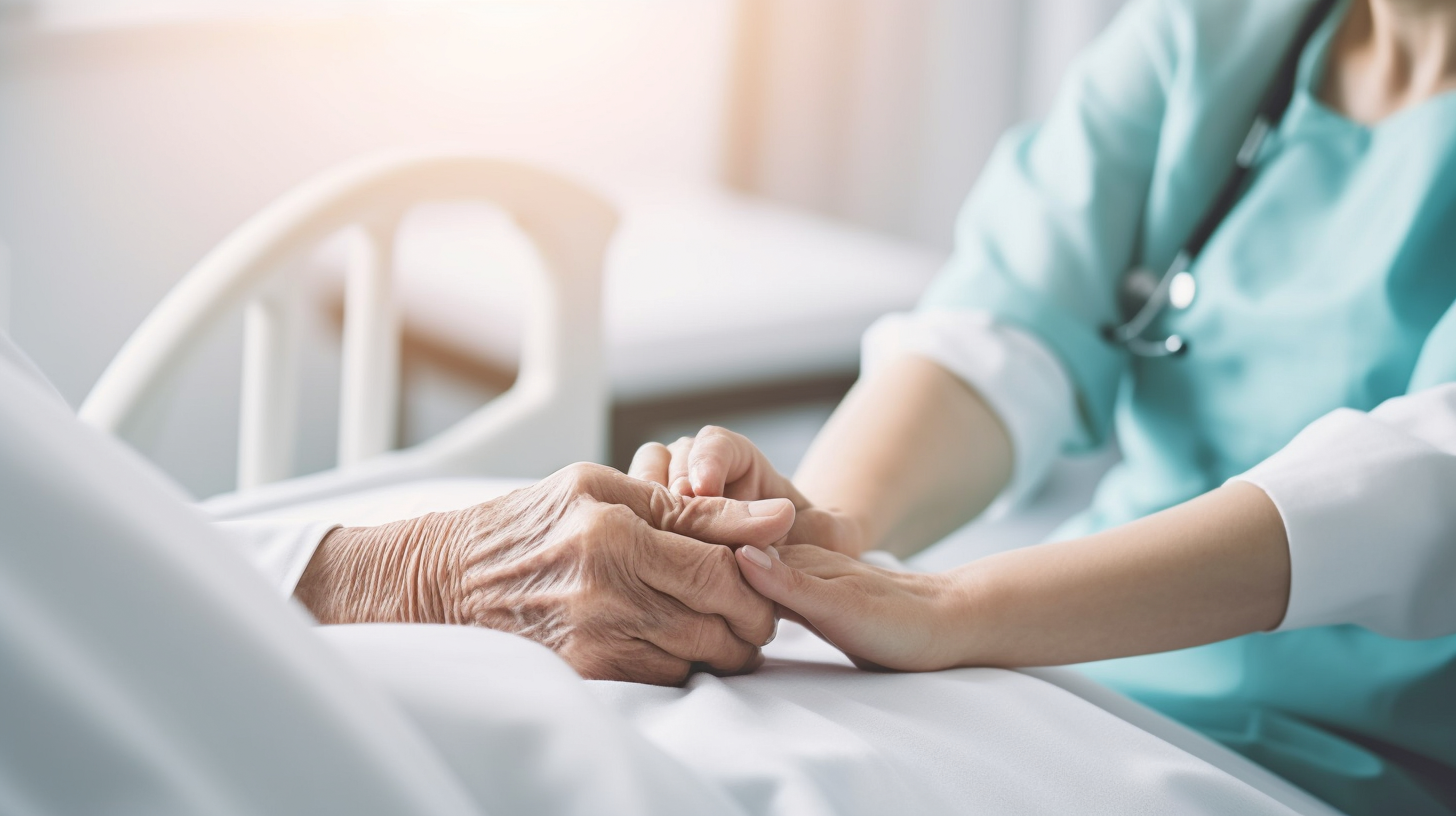Caregiver holding a patient's hand
